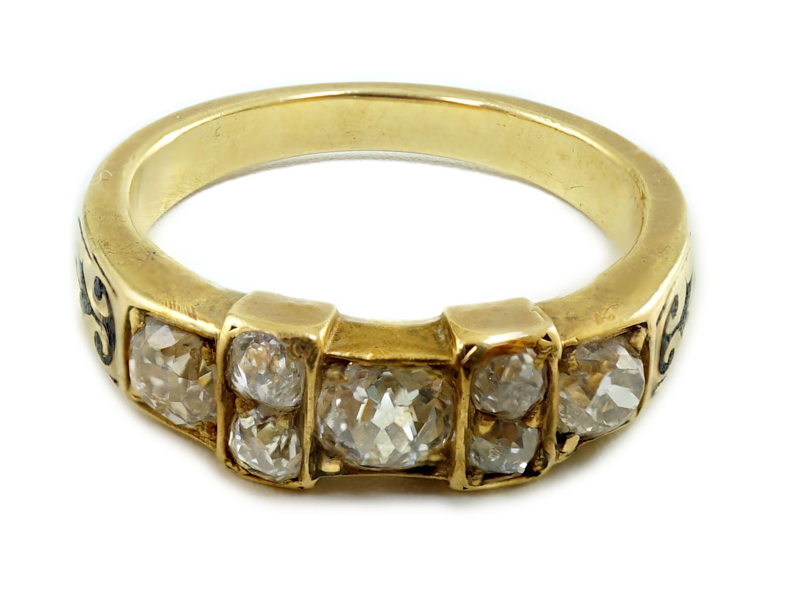 A late 19th century gold and seven stone old mine cut diamond and black enamelled cluster half hoop ring